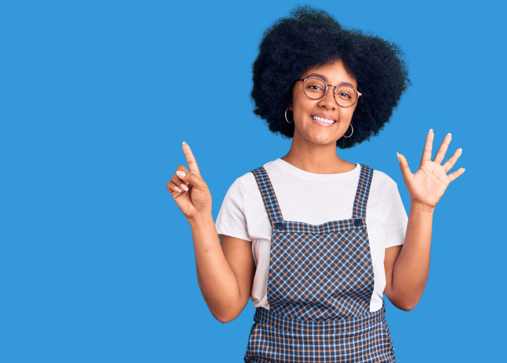 Young african american girl wearing casual clothes showing and pointing up with fingers number six