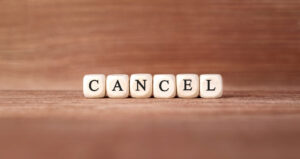 Word CANCEL made with wood building blocks