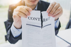Cancellation of the contract. Businessman tear the contract.